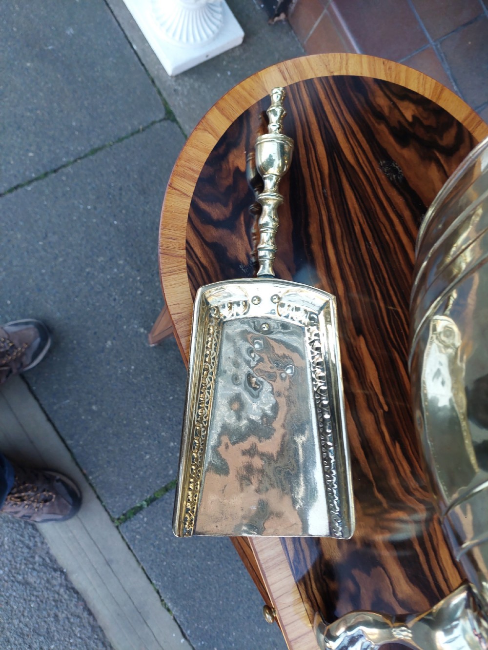 A Victorian silver-plated barrel-shaped coal scuttle resting on three claw feet with an engraved crest and attached scoop. View II