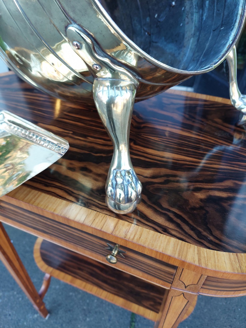 A Victorian silver-plated barrel-shaped coal scuttle resting on three claw feet with an engraved crest and attached scoop. View IV