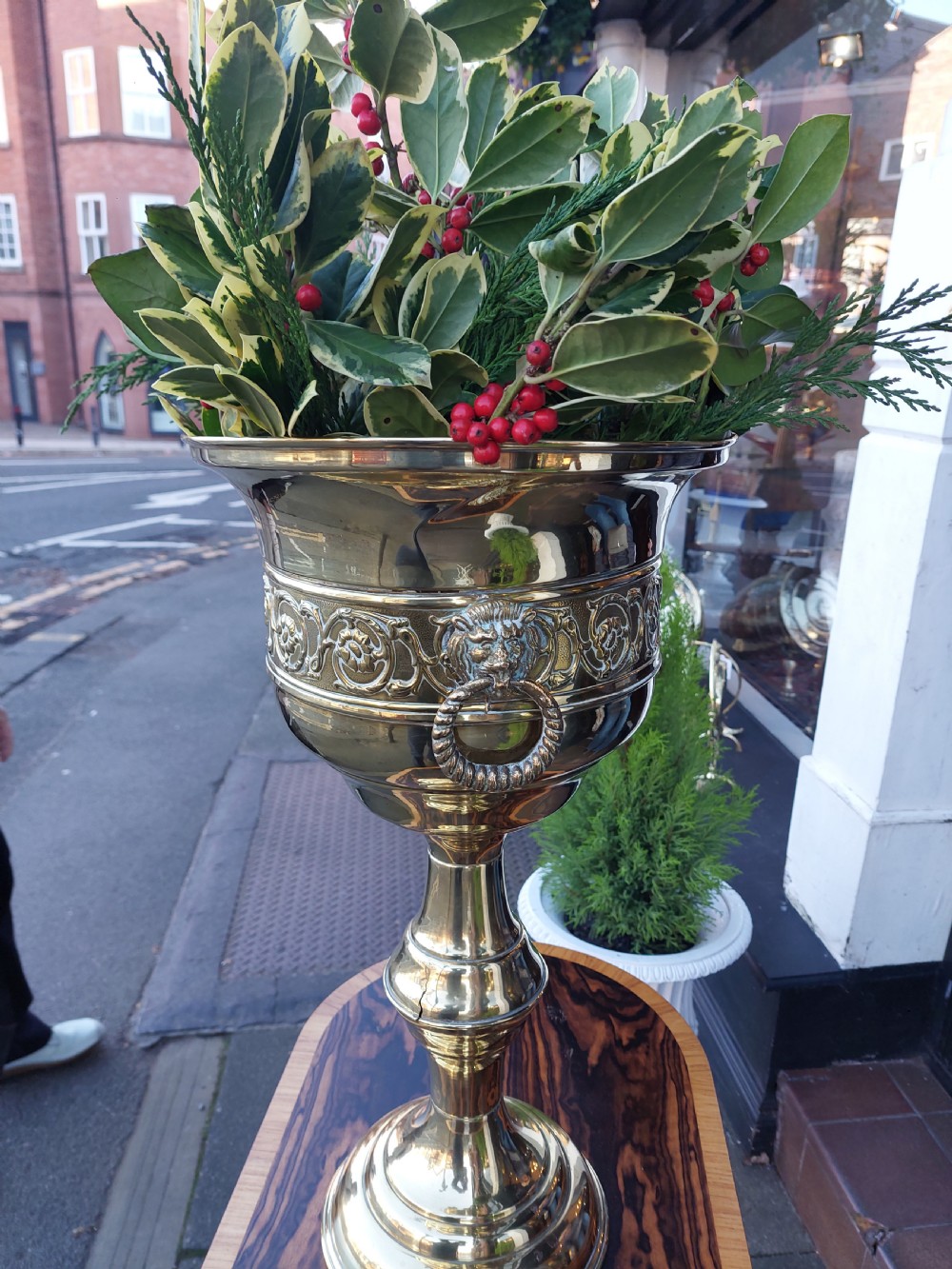A polished late nineteenth-century pressed brass urn planter positioned on a turned pedestal base. View IV