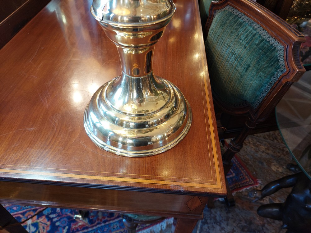 A polished late nineteenth-century pressed brass urn planter positioned on a turned pedestal base. View V