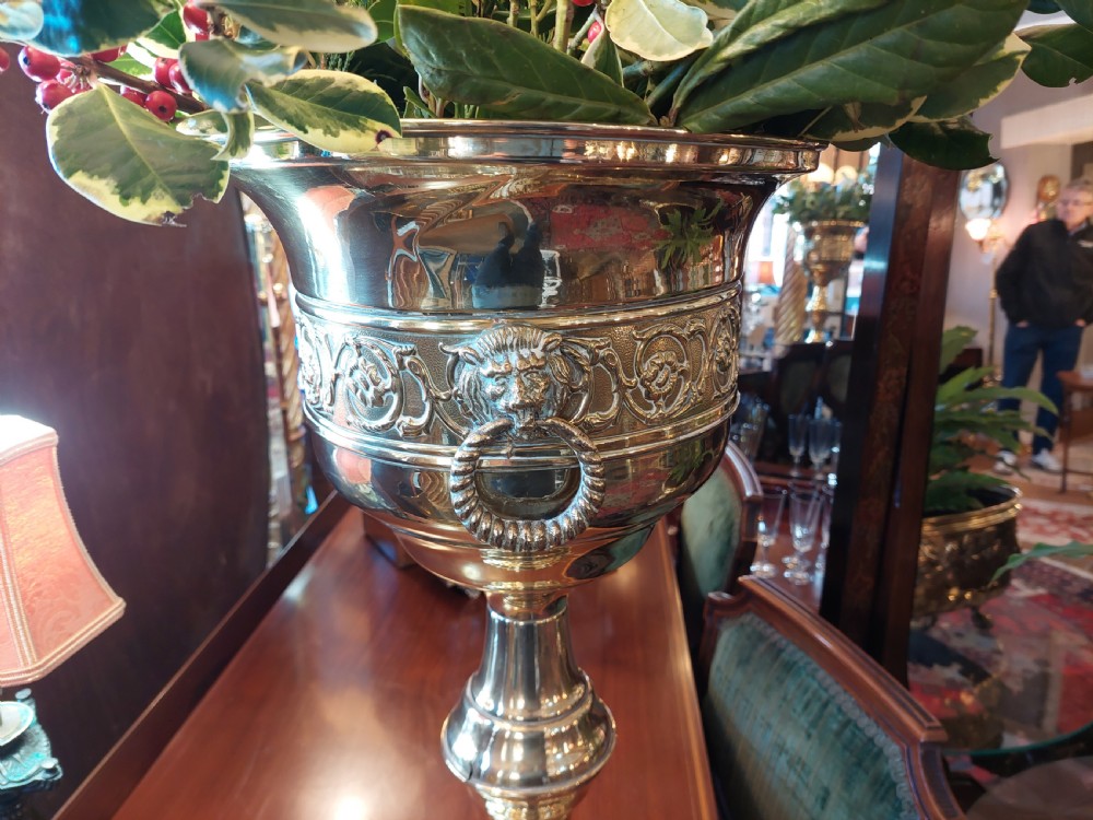 A polished late nineteenth-century pressed brass urn planter positioned on a turned pedestal base. View VI