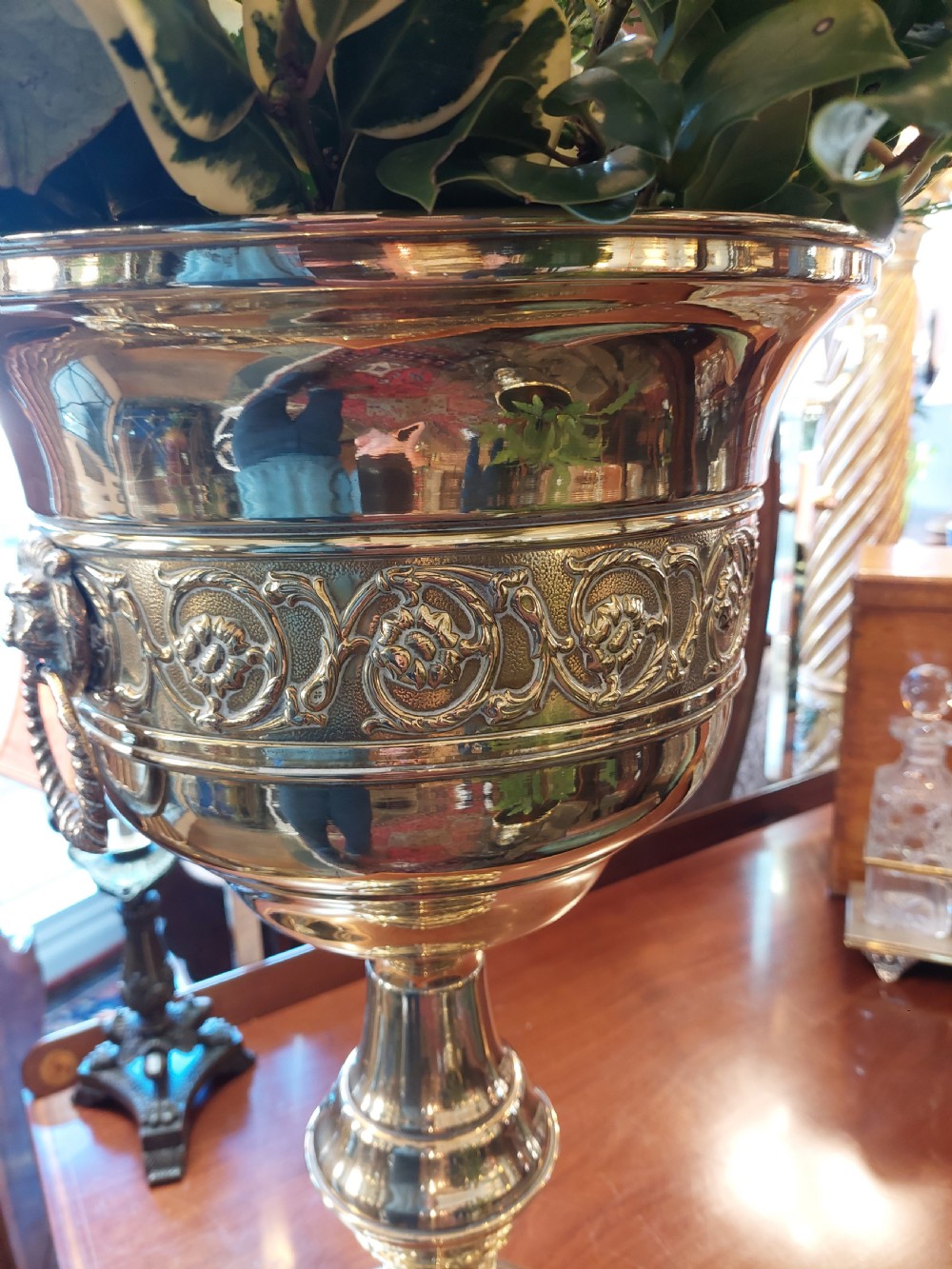 A polished late nineteenth-century pressed brass urn planter positioned on a turned pedestal base. View VIII