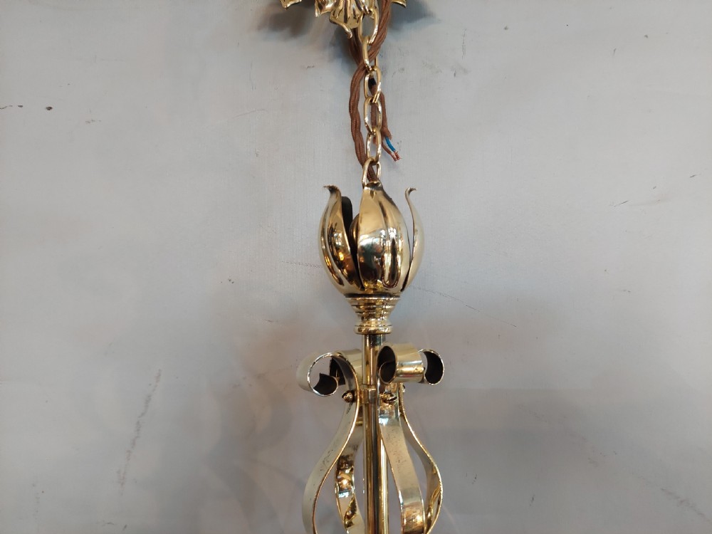 An Art Nouveau ceiling pendant light featuring polished brass scrollwork and leaf detailing suspending a swirled pale green glass globe shade. View VII