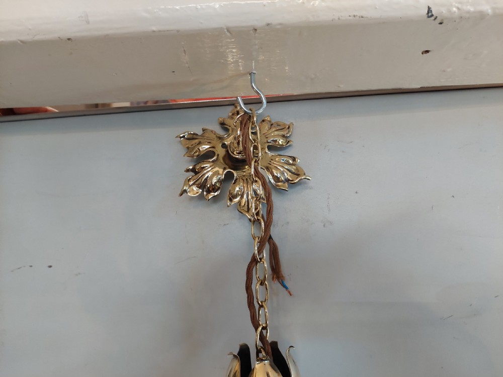 An Art Nouveau ceiling pendant light featuring polished brass scrollwork and leaf detailing suspending a swirled pale green glass globe shade. View VIII