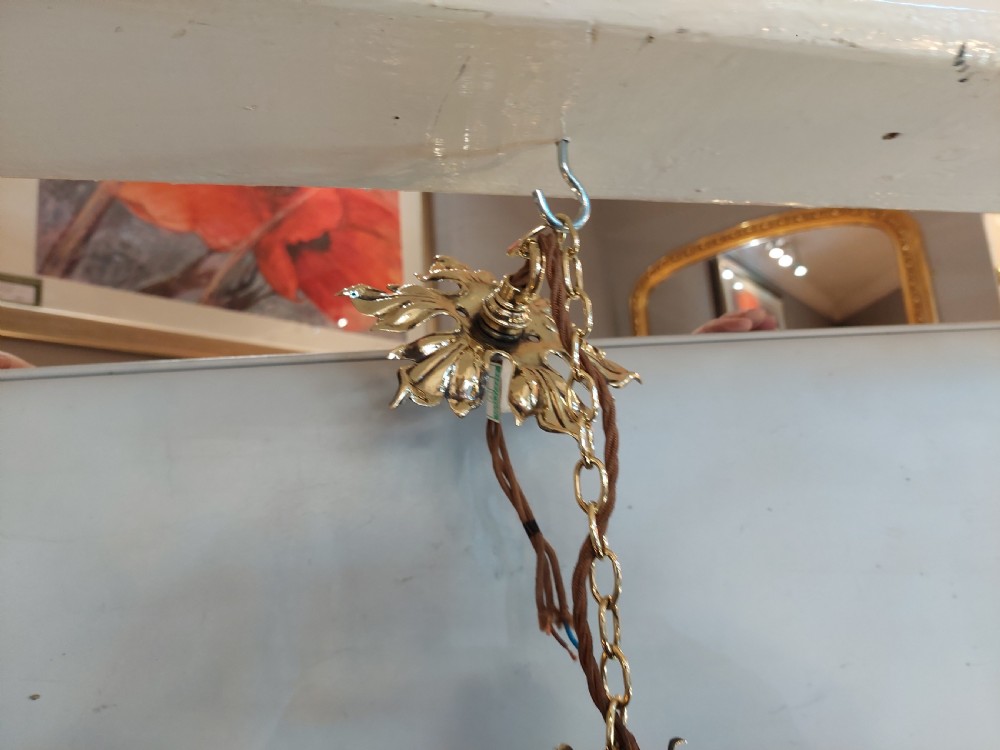 An Art Nouveau ceiling pendant light featuring polished brass scrollwork and leaf detailing suspending a swirled pale green glass globe shade. View IX