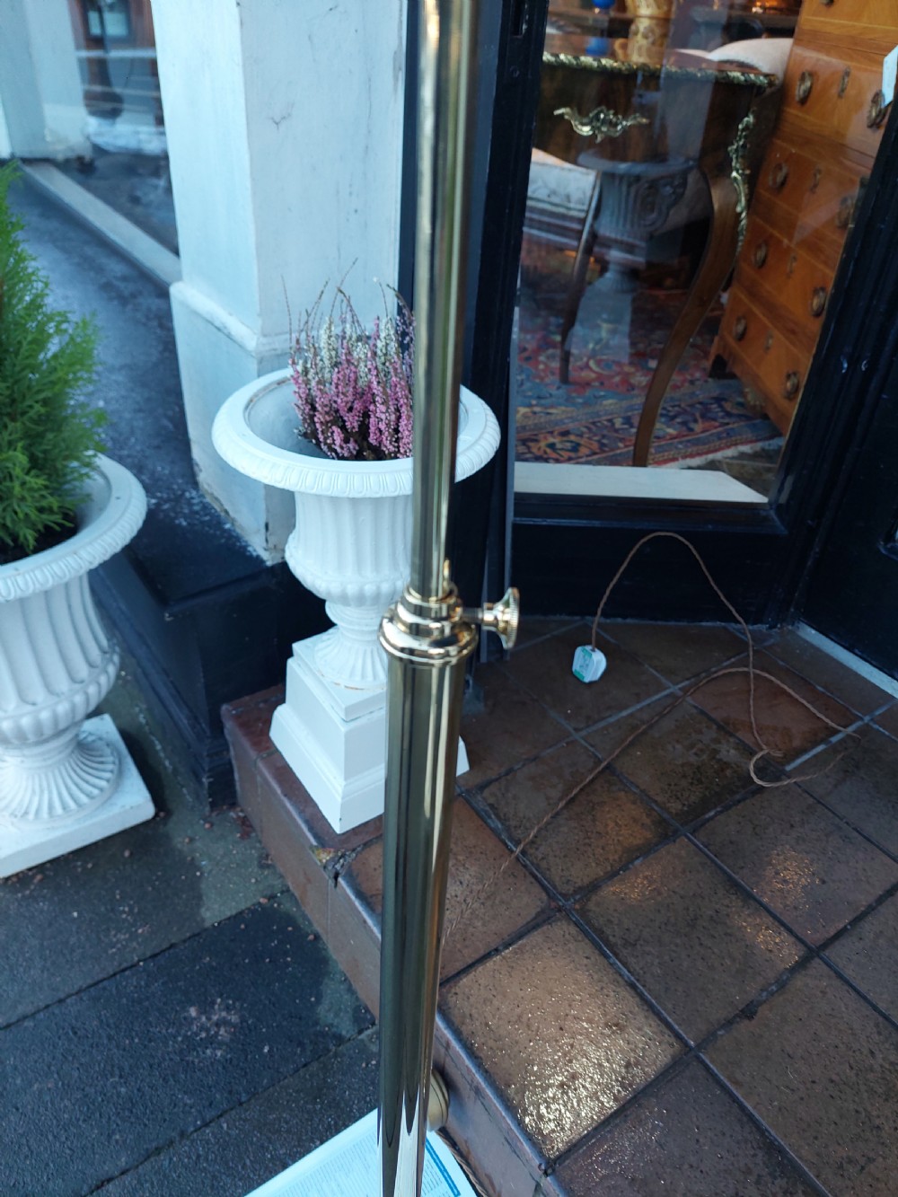 An early twentieth-century adjustable floor lamp with a metallic stem, gooseneck arm, and a frilled cranberry glass shade. View IV
