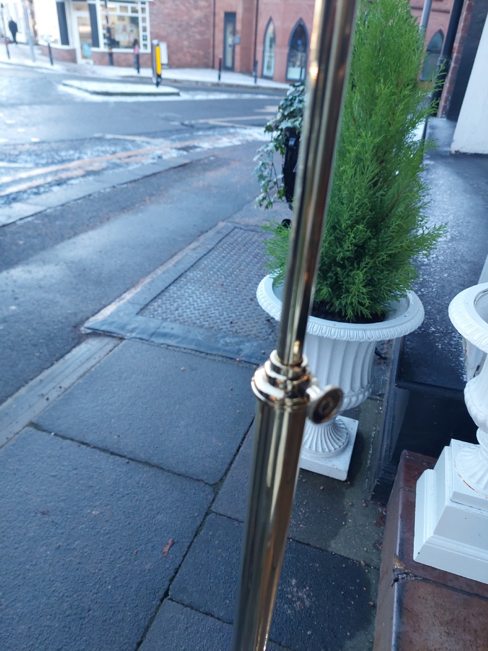 An early twentieth-century adjustable floor lamp with a metallic stem, gooseneck arm, and a frilled cranberry glass shade. View V