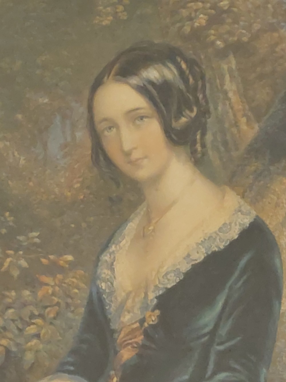 A framed 19th-century colour print depicting a seated woman in a dark green dress holding a letter, set within a wide timber veneer frame with a gilt inner slip. View II