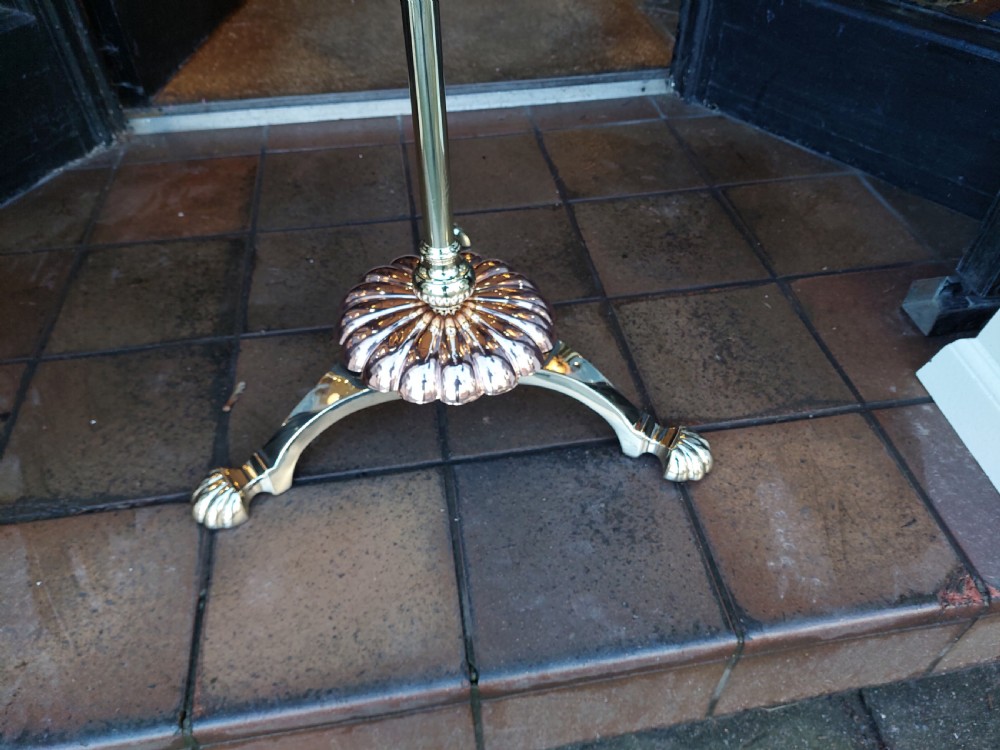 A late 19th-century brass and copper floor-standing oil lamp featuring claw feet and a cranberry glass font and shade. View II