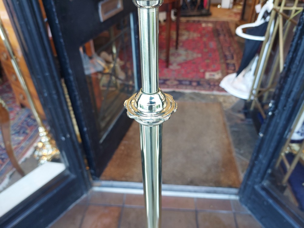 A late 19th-century brass and copper floor-standing oil lamp featuring claw feet and a cranberry glass font and shade. View V