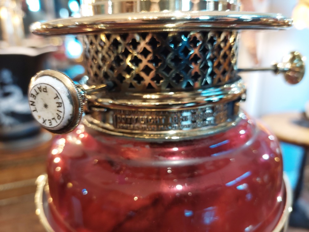 A late 19th-century brass and copper floor-standing oil lamp featuring claw feet and a cranberry glass font and shade. View XI