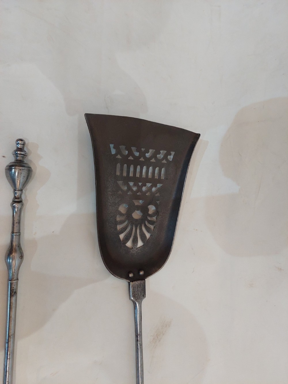 A pair of Georgian steel fire tools consisting of a poker and a shovel with a pierced decorative blade. View III