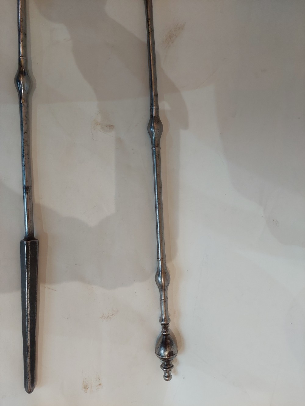A pair of Georgian steel fire tools consisting of a poker and a shovel with a pierced decorative blade. View IV