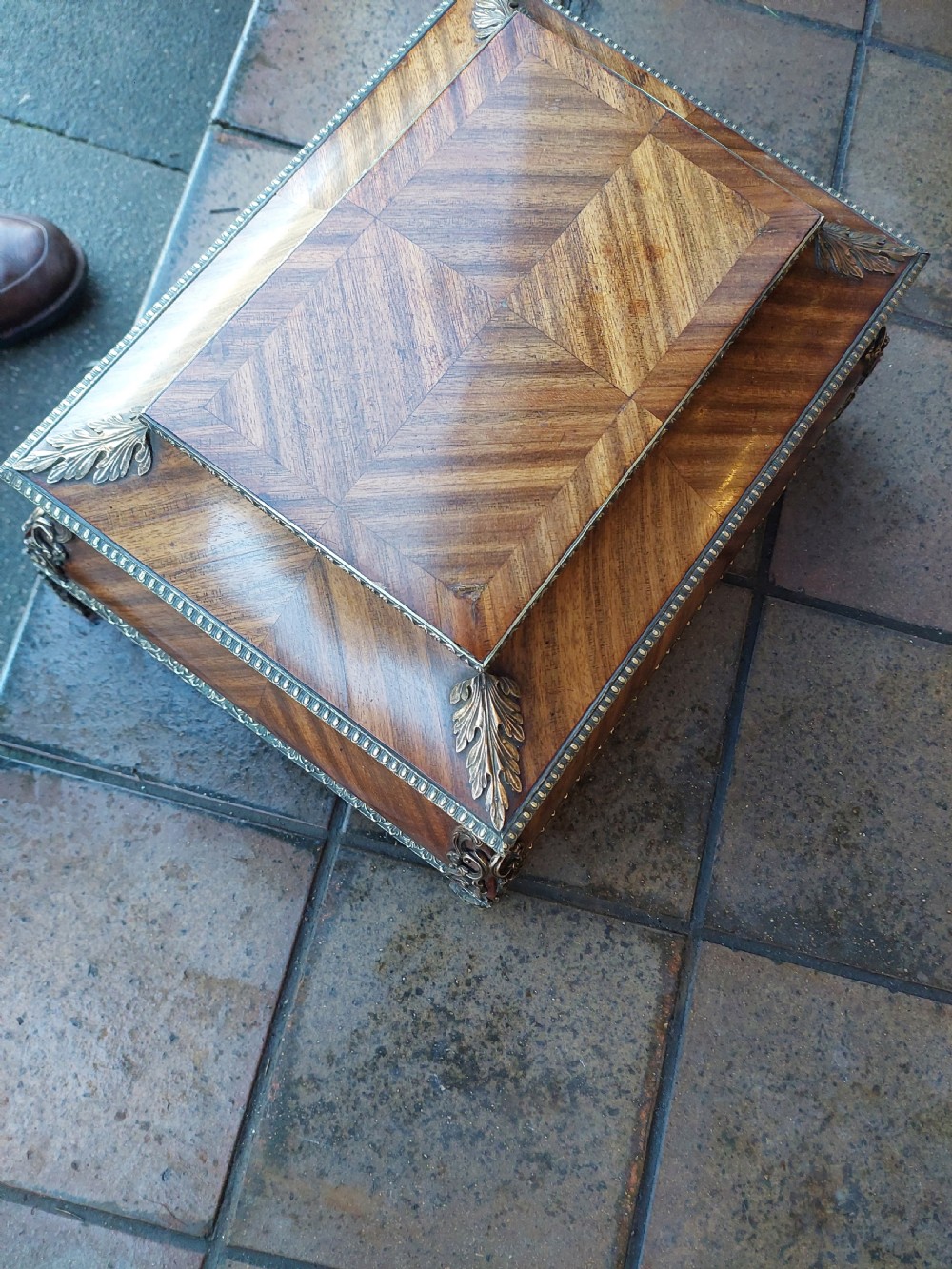 A Victorian kingwood jewellery box featuring a parquetry veneer pattern, serpentine sides, and silver-coloured ornamental corner mounts. View III