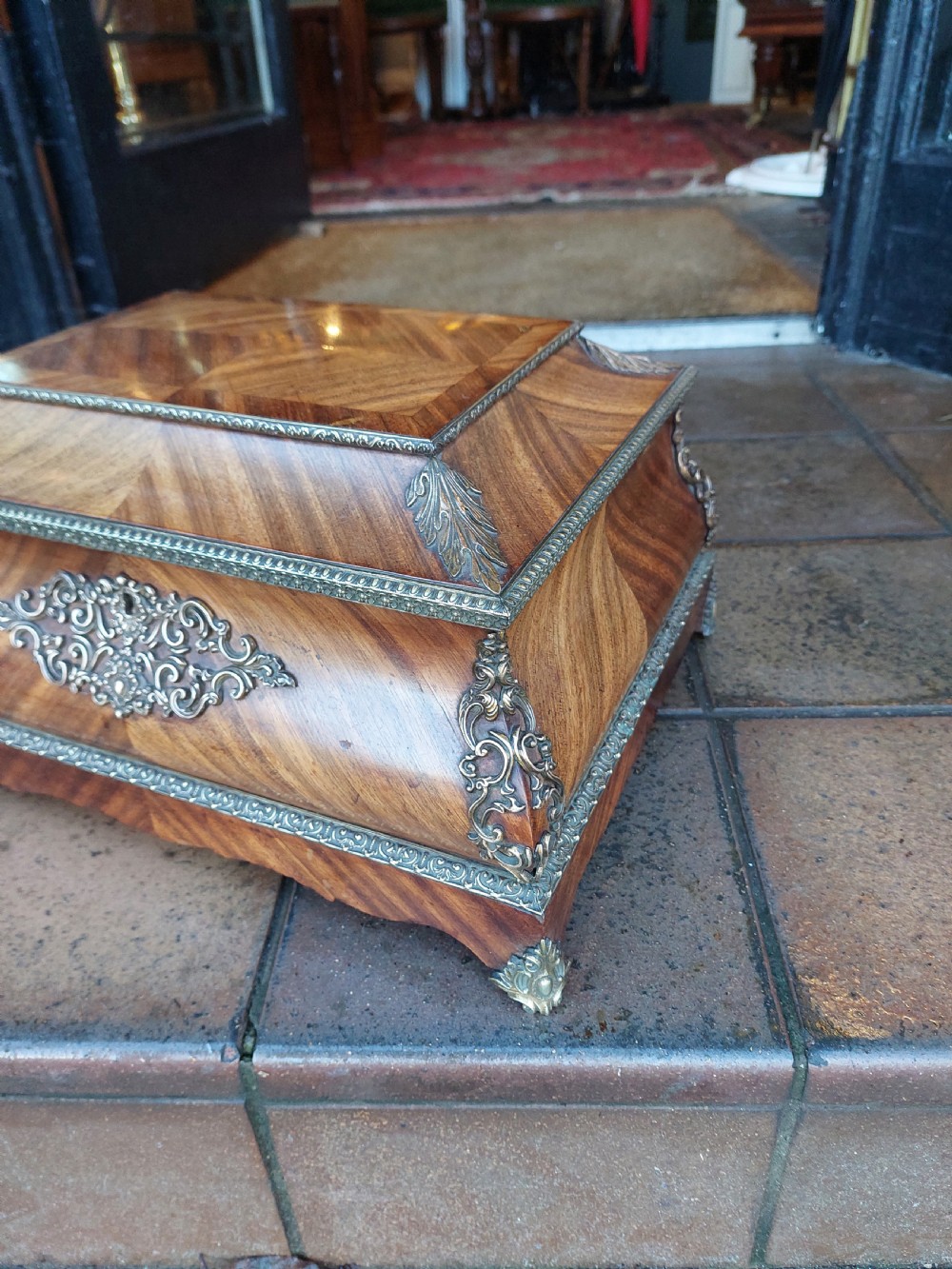 A Victorian kingwood jewellery box featuring a parquetry veneer pattern, serpentine sides, and silver-coloured ornamental corner mounts. View IV