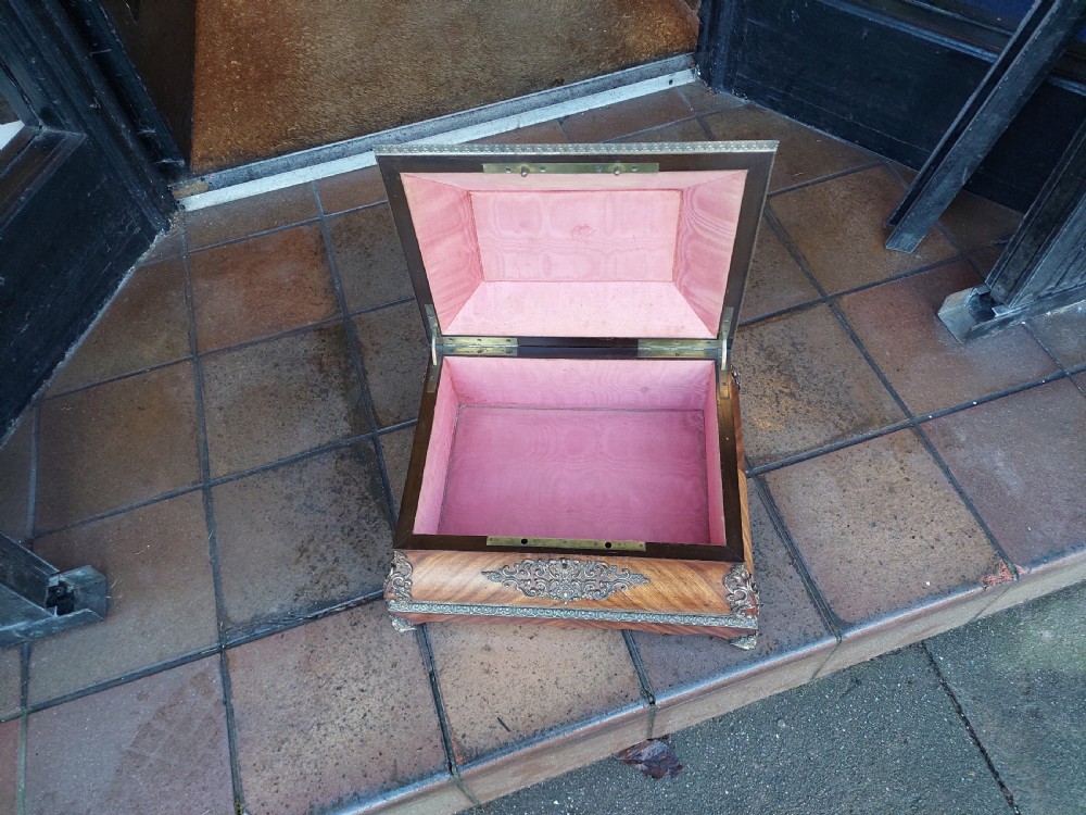 A Victorian kingwood jewellery box featuring a parquetry veneer pattern, serpentine sides, and silver-coloured ornamental corner mounts. View VII