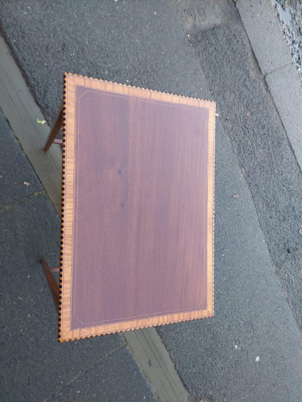 An Edwardian rectangular mahogany occasional table featuring geometric inlaid border decoration and slender square tapered legs. View II