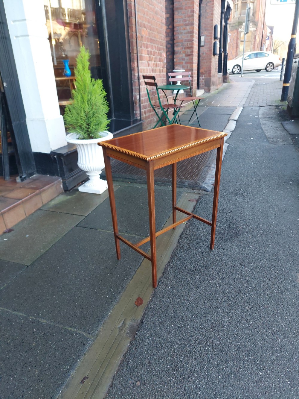 An Edwardian rectangular mahogany occasional table featuring geometric inlaid border decoration and slender square tapered legs. View III