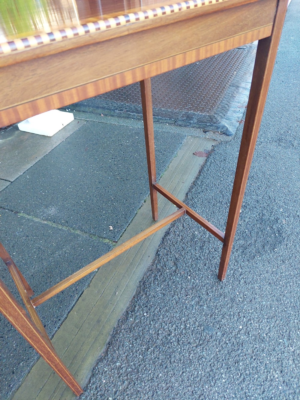 An Edwardian rectangular mahogany occasional table featuring geometric inlaid border decoration and slender square tapered legs. View VI
