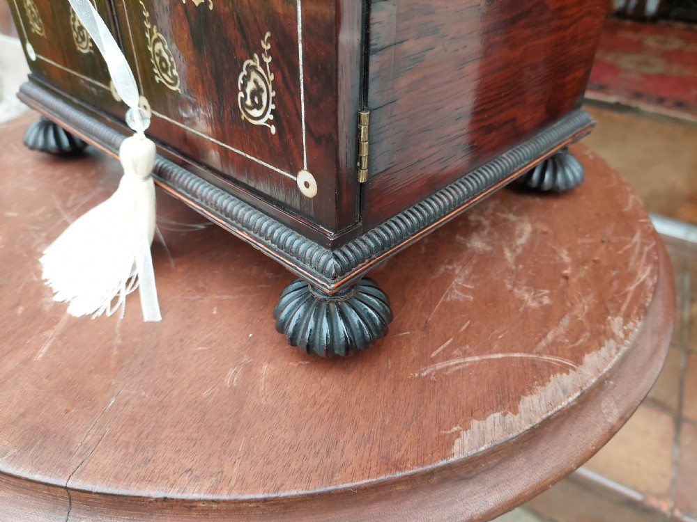 A nineteenth-century dark rosewood jewellery cabinet featuring mother-of-pearl decorative inlay, two front doors, a stepped lid, and turned feet. View VII