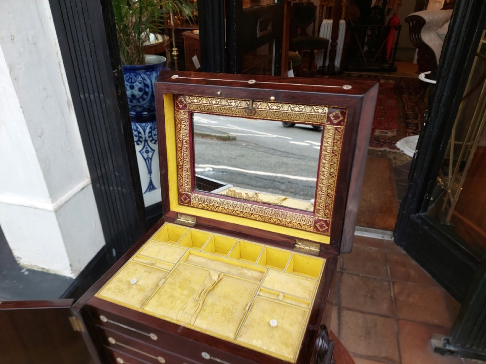 A nineteenth-century dark rosewood jewellery cabinet featuring mother-of-pearl decorative inlay, two front doors, a stepped lid, and turned feet. View VIII
