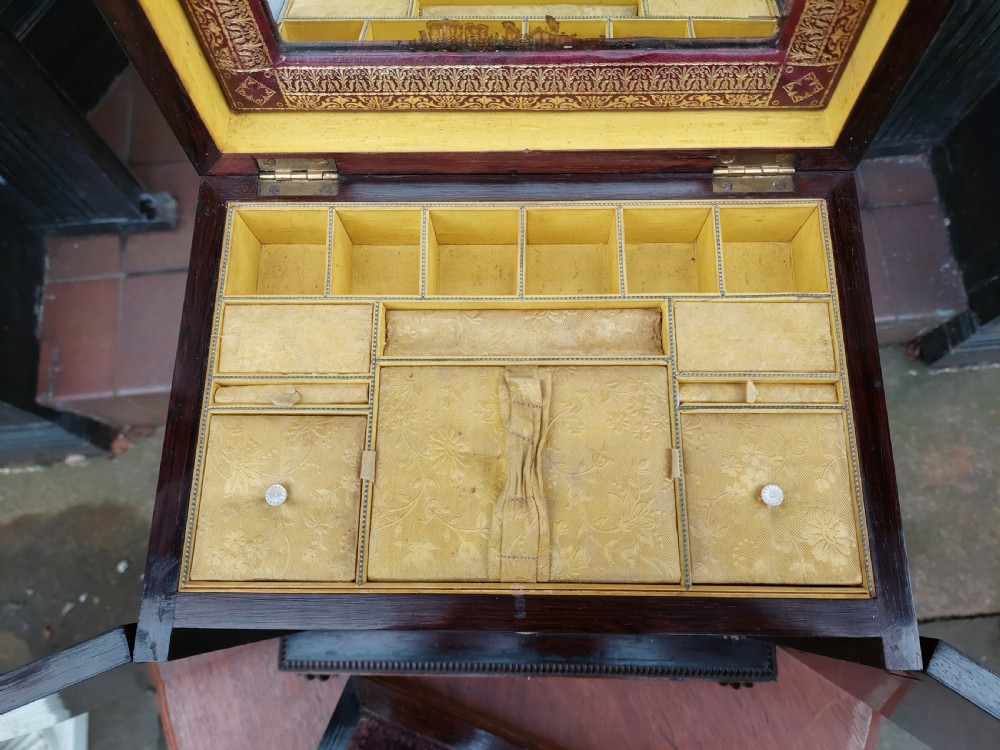 A nineteenth-century dark rosewood jewellery cabinet featuring mother-of-pearl decorative inlay, two front doors, a stepped lid, and turned feet. View IX