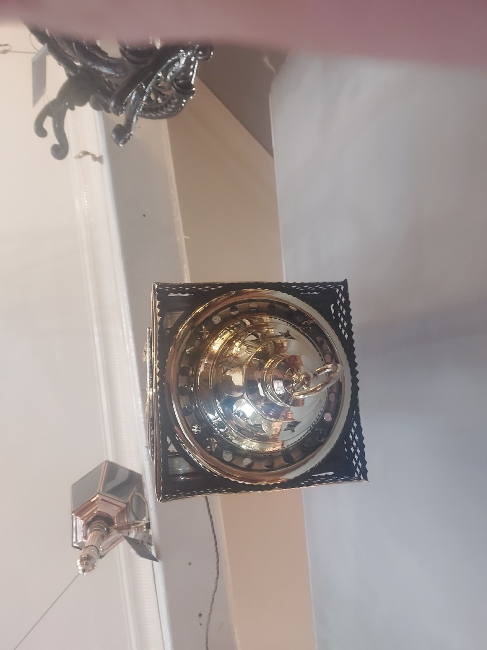 A Victorian hanging brass lantern with rectangular leaded glass panels displaying diamond motifs and suspended by delicate chains. View II