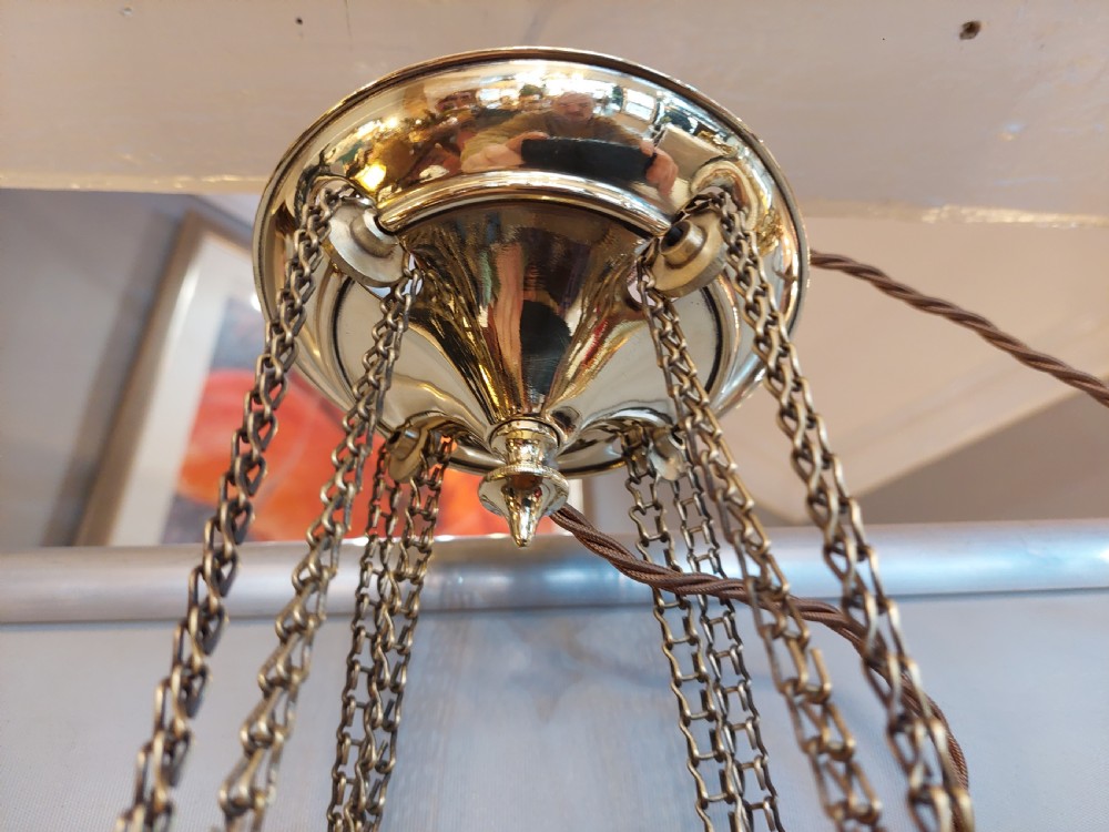 A Victorian hanging brass lantern with rectangular leaded glass panels displaying diamond motifs and suspended by delicate chains. View IX