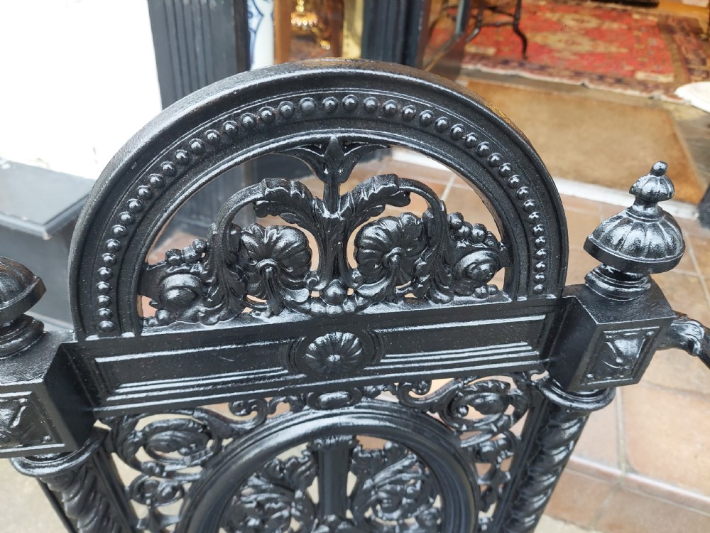 A black painted cast iron stick stand featuring elaborate foliate scrollwork, twisted rope columns, and a removable drip tray base. View IV