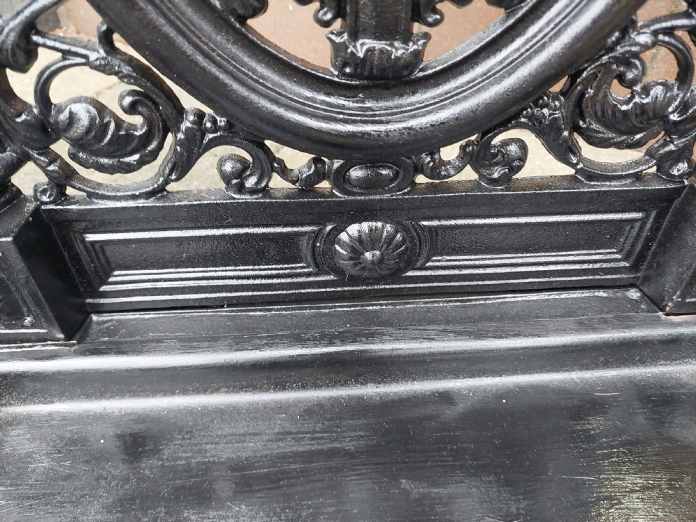 A black painted cast iron stick stand featuring elaborate foliate scrollwork, twisted rope columns, and a removable drip tray base. View VI