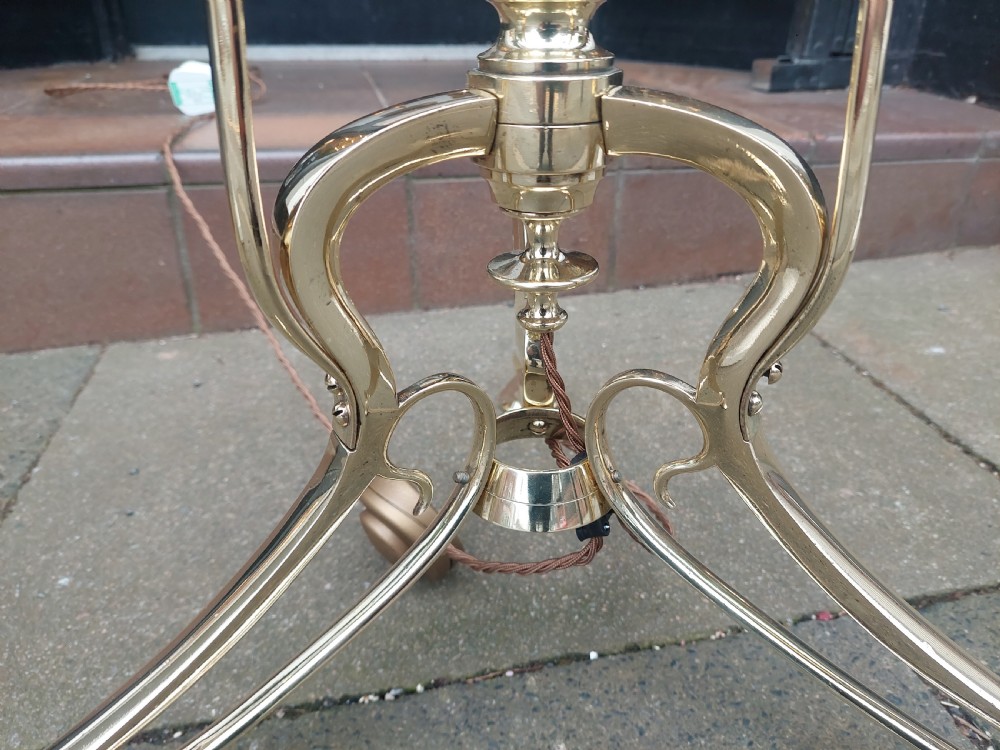 An Art Nouveau brass standard floor lamp featuring curved organic metalwork on a tripod base topped with a patterned floral fabric drum shade. View IV