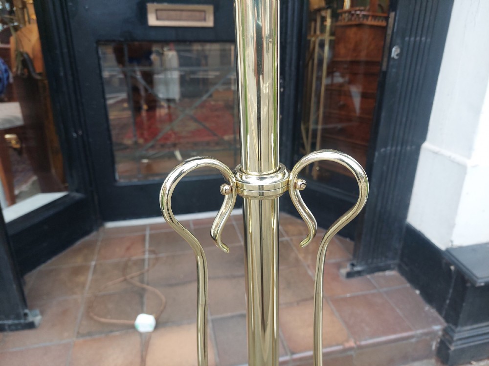 An Art Nouveau brass standard floor lamp featuring curved organic metalwork on a tripod base topped with a patterned floral fabric drum shade. View V