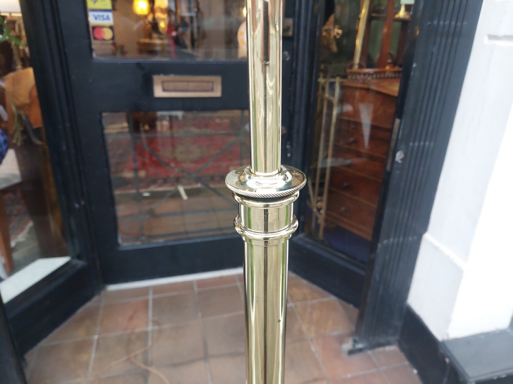 An Art Nouveau brass standard floor lamp featuring curved organic metalwork on a tripod base topped with a patterned floral fabric drum shade. View VI