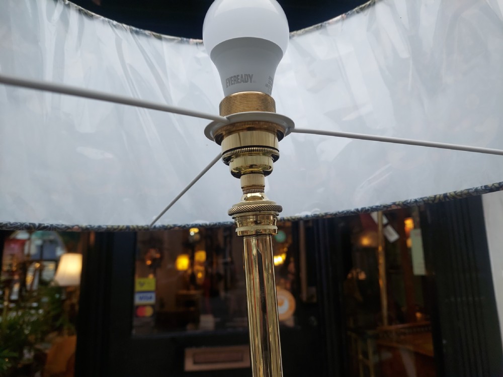An Art Nouveau brass standard floor lamp featuring curved organic metalwork on a tripod base topped with a patterned floral fabric drum shade. View VII