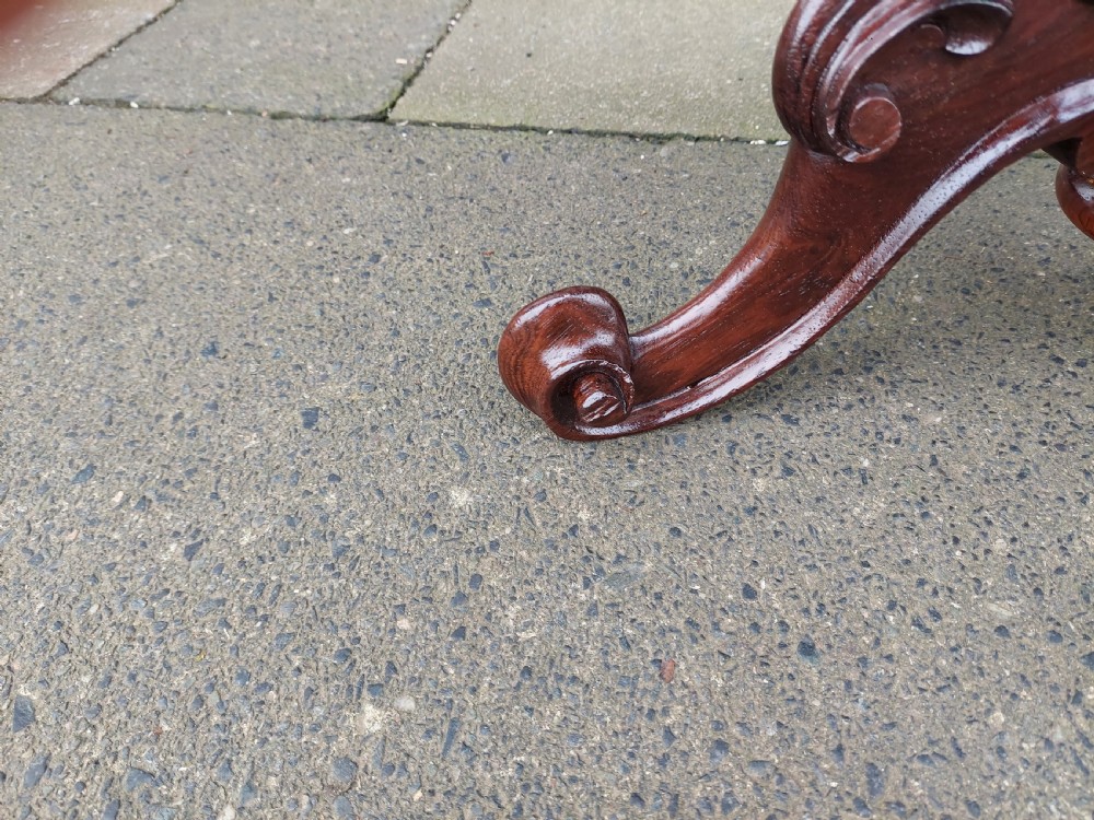 A late Victorian revolving piano stool featuring a carved rosewood tripod base and a circular padded seat with floral embroidery. View IV