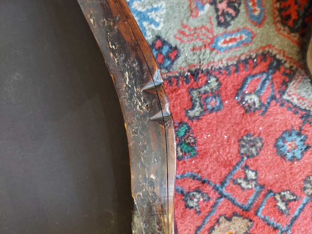 A Victorian mahogany stool featuring dark buttoned black leather upholstery with brass studding and four carved cabriole legs. View VIII