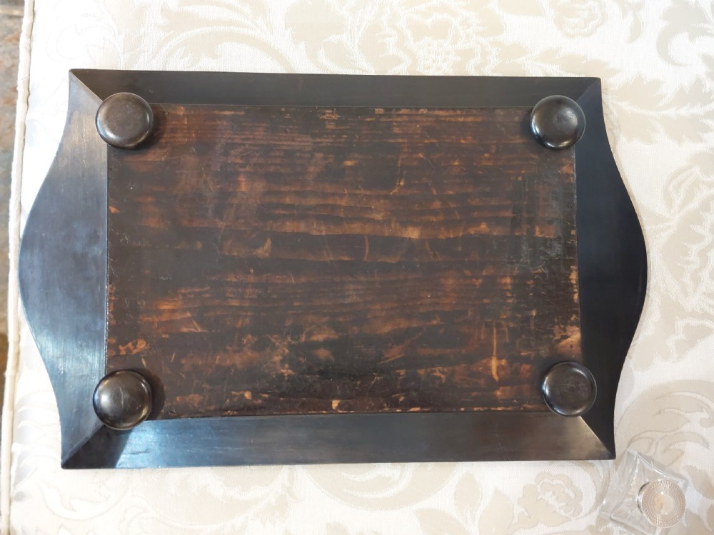 A mid-19th-century dark coromandel wood inkstand desk tidy featuring floral inlay, a pen trough, two lidded compartments, and a central glass inkwell. View VIII