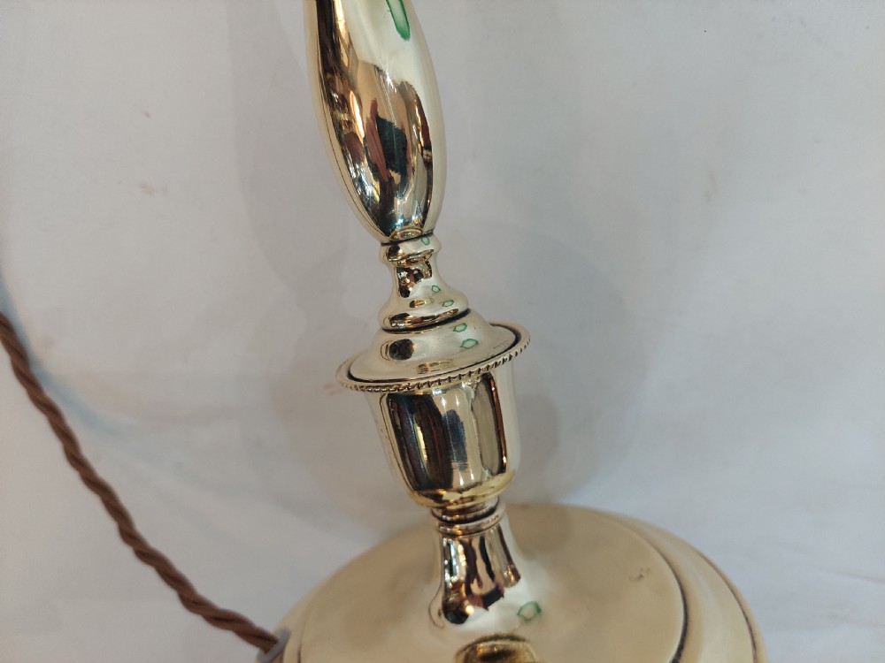 An early twentieth-century polished brass swan neck desk lamp with a turned stem and a frosted glass shade featuring etched detailing and a green ruffled rim. View V