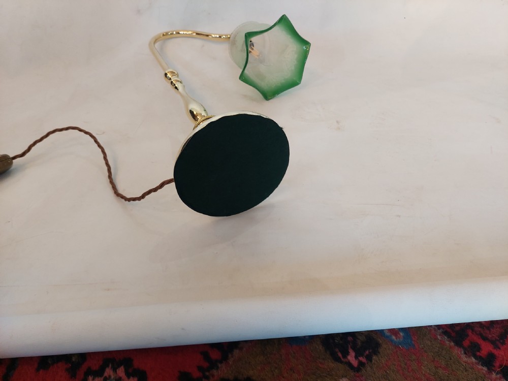 An early twentieth-century polished brass swan neck desk lamp with a turned stem and a frosted glass shade featuring etched detailing and a green ruffled rim. View VI