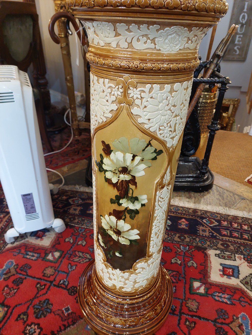 A Victorian Burmantofts majolica ceramic jardiniere and matching pedestal stand featuring painted floral panels and cream relief scrollwork on an ochre glaze. View II