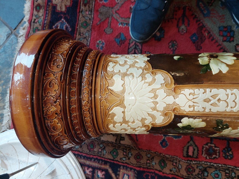 A Victorian Burmantofts majolica ceramic jardiniere and matching pedestal stand featuring painted floral panels and cream relief scrollwork on an ochre glaze. View IX
