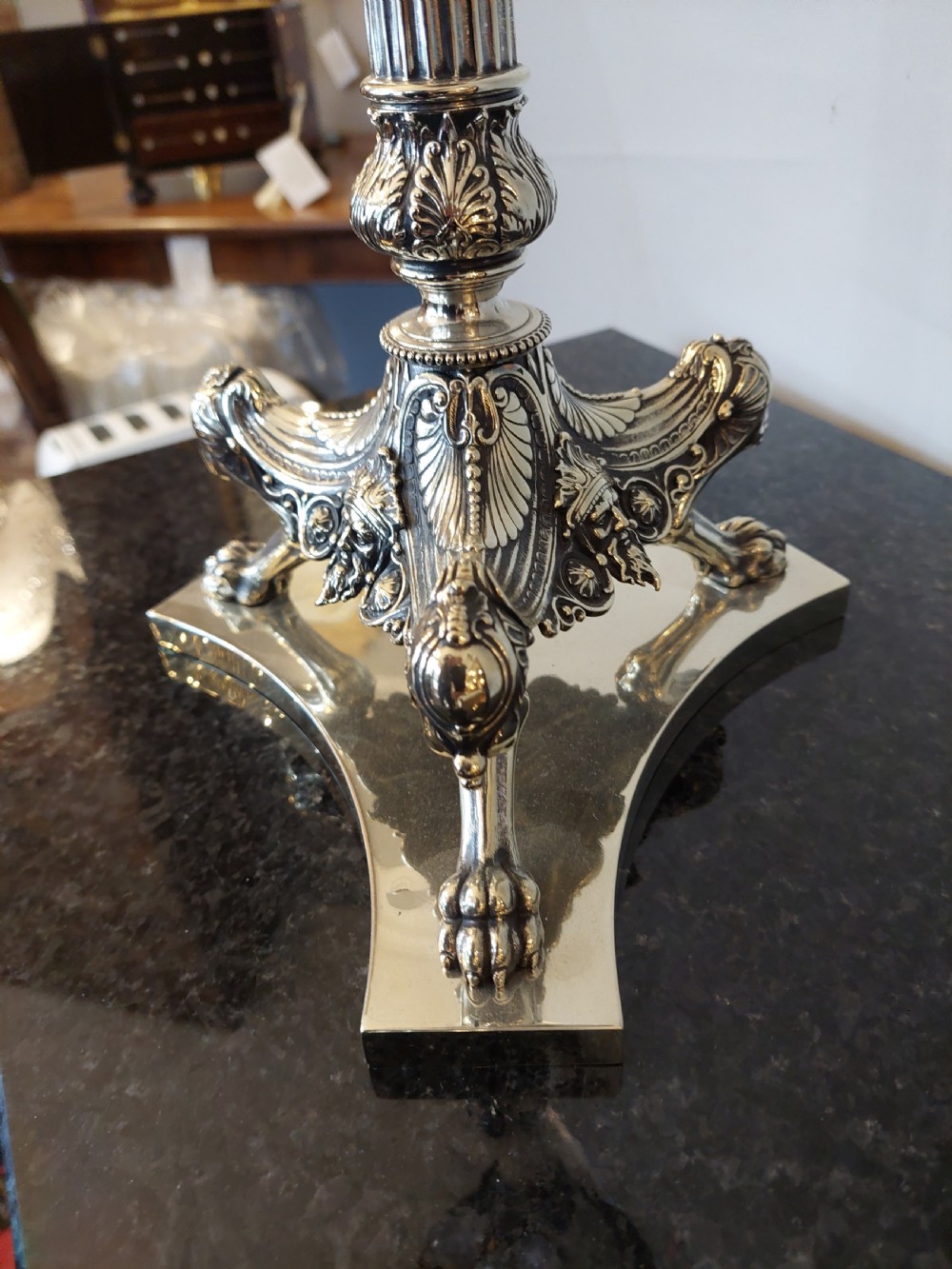 A late Victorian silver-plated oil lamp featuring a fluted column stem, a red cranberry glass reservoir, a brass burner, and a frosted etched glass shade. View VII