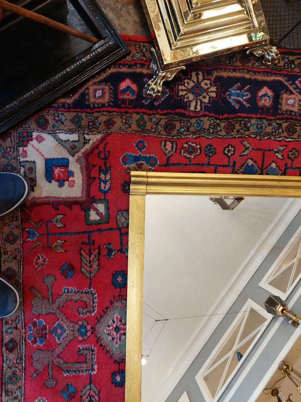A Victorian giltwood overmantel mirror featuring an arched frame topped with an intricate rococo cresting of acanthus leaves and shell motifs. View III