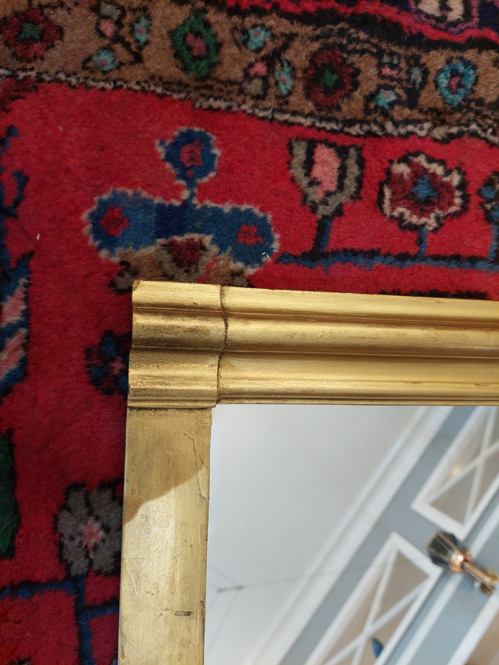 A Victorian giltwood overmantel mirror featuring an arched frame topped with an intricate rococo cresting of acanthus leaves and shell motifs. View IV