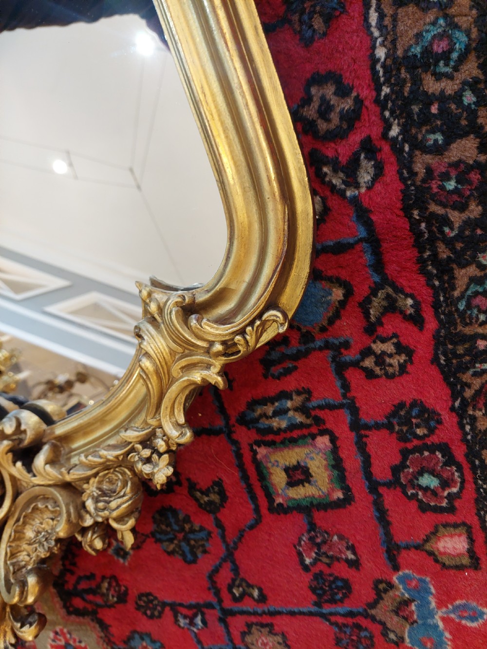 A Victorian giltwood overmantel mirror featuring an arched frame topped with an intricate rococo cresting of acanthus leaves and shell motifs. View VII