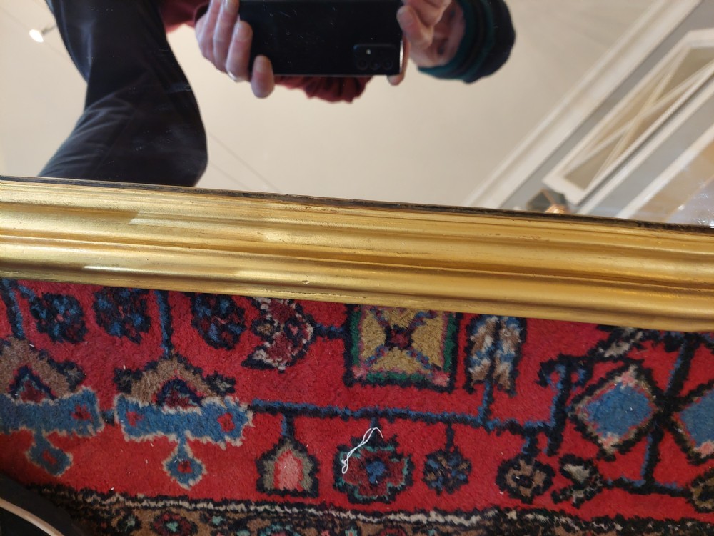 A Victorian giltwood overmantel mirror featuring an arched frame topped with an intricate rococo cresting of acanthus leaves and shell motifs. View VIII