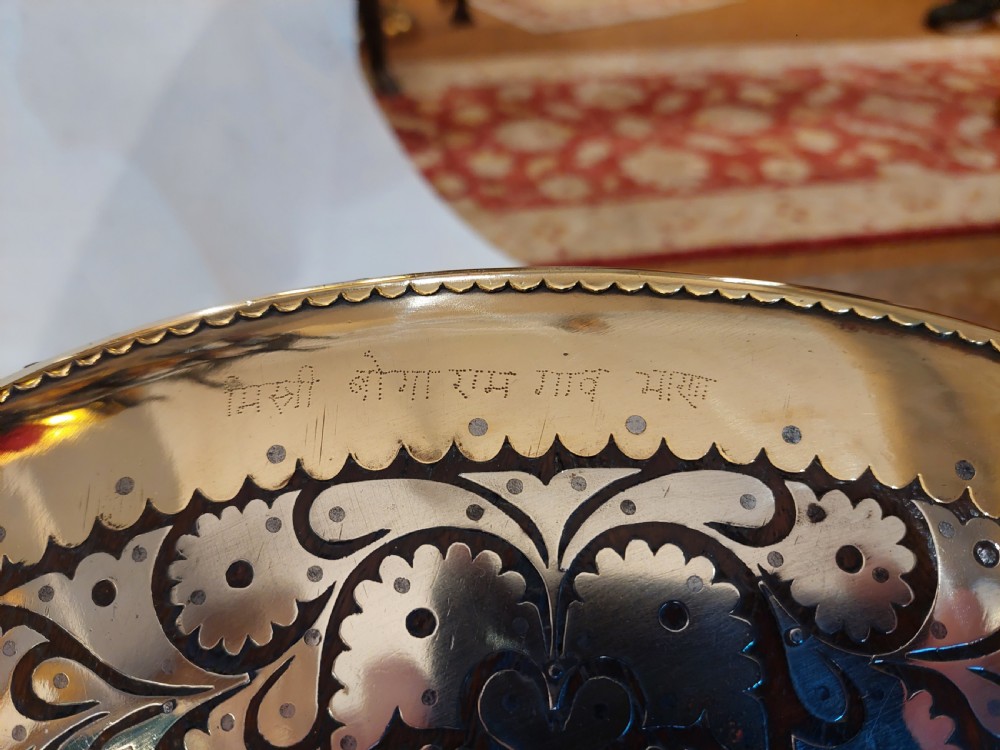 An antique ceremonial camel saddle frame featuring arched pommels clad in chased brass and silvered metal with floral engraving. View VI
