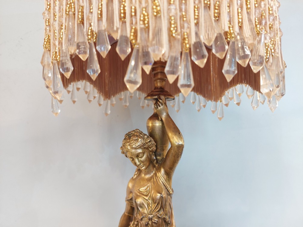 An antique Victorian cold-painted bronze table lamp shaped as a classical standing female figure on a green marble base, topped with a pink silk fringed shade. View VI