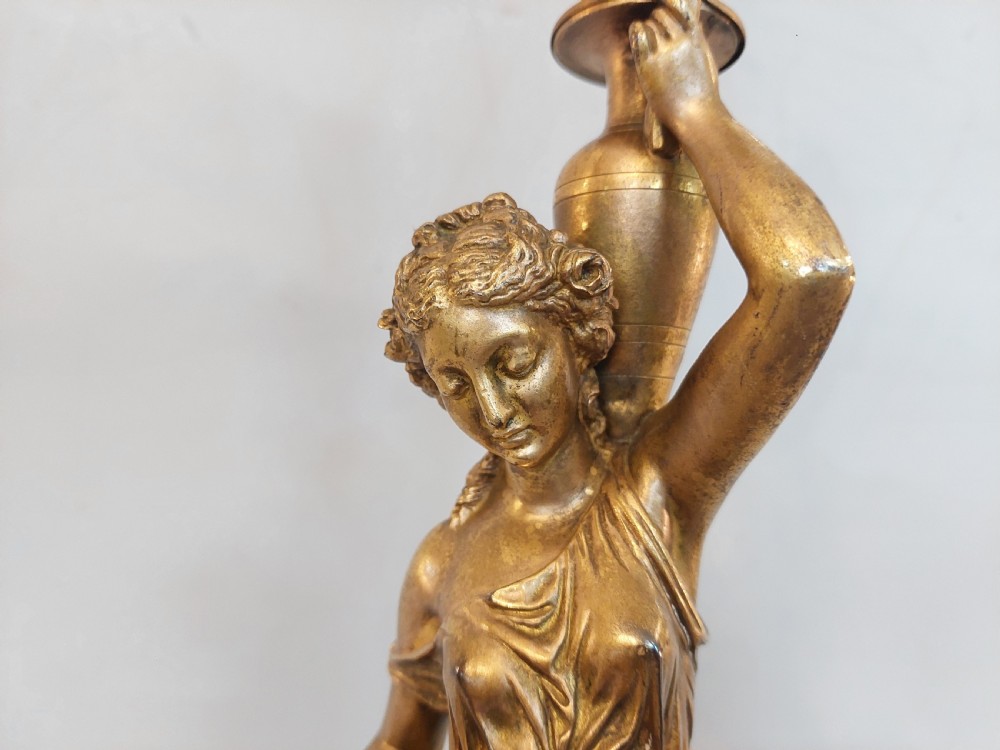 An antique Victorian cold-painted bronze table lamp shaped as a classical standing female figure on a green marble base, topped with a pink silk fringed shade. View VII