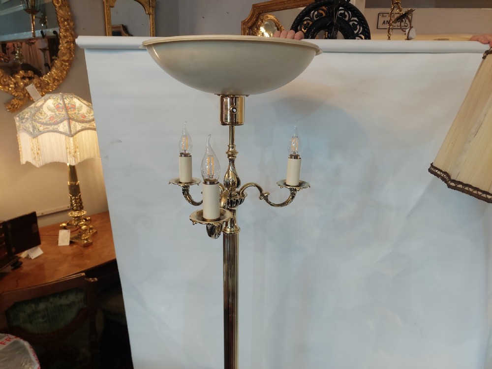 A pair of 1920s polished brass standard floor lamps featuring reeded columns, decorative cast bases, and pleated fabric shades. View IX